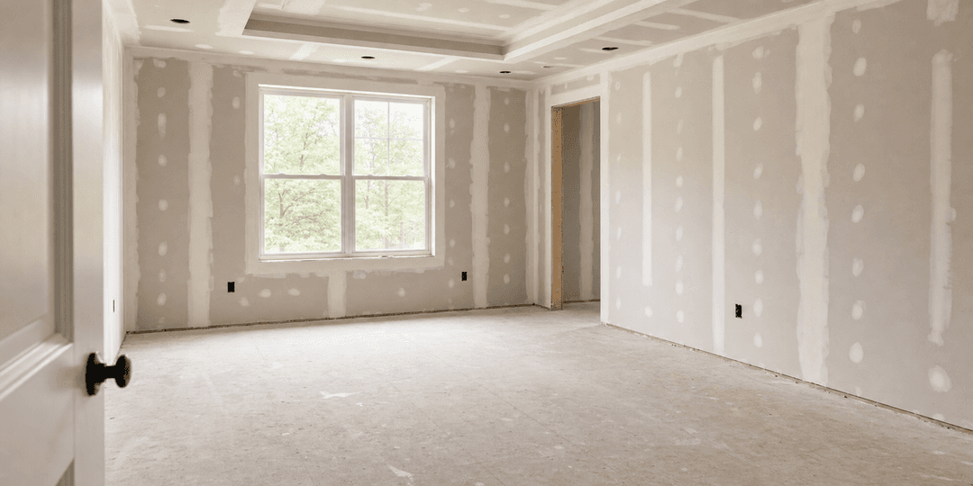 Unfinished drywall room ready for a walkthrough